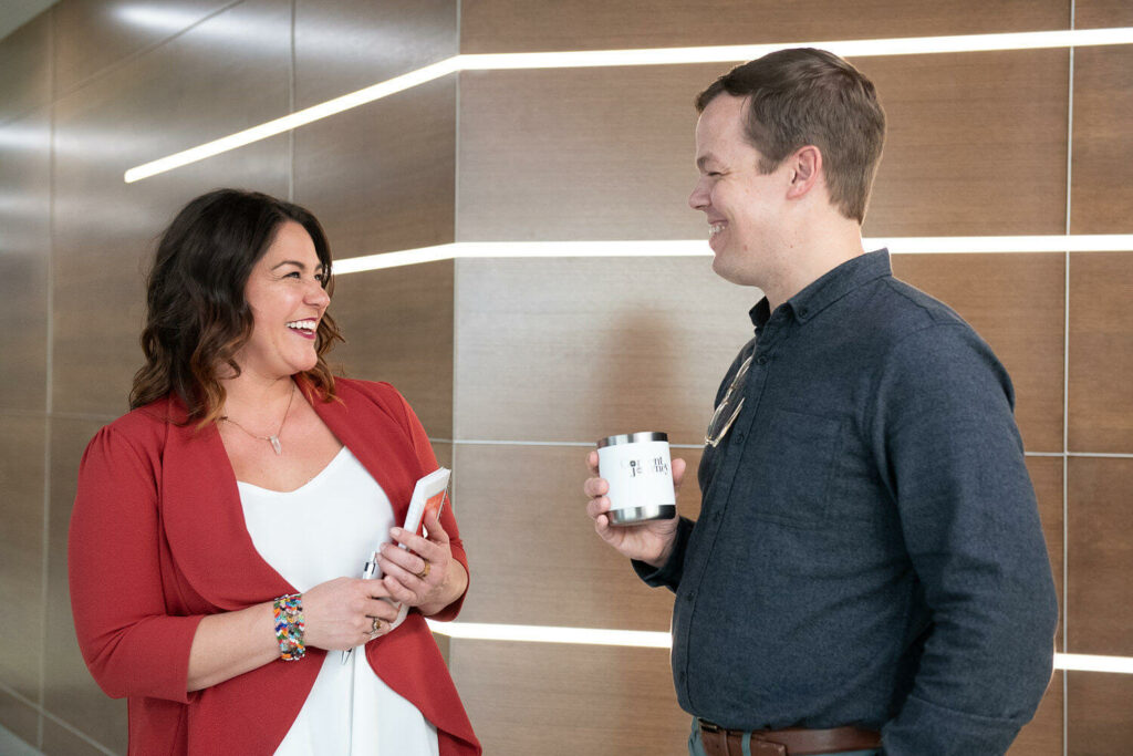 A man and woman talking in an office building