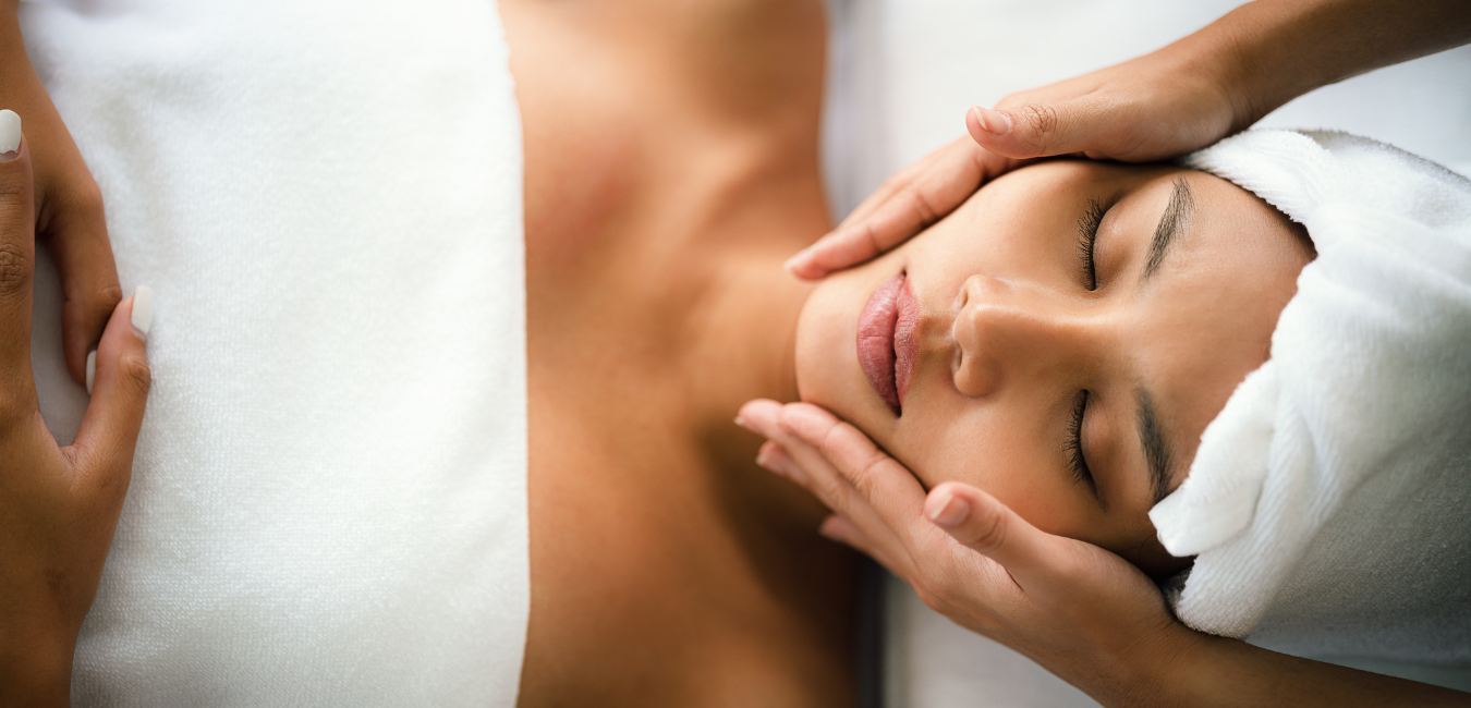 A woman laying on a table, getting a facial